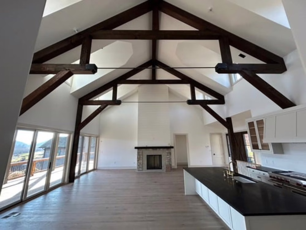 Staining services on vaulted wooden beams in a spacious living room.