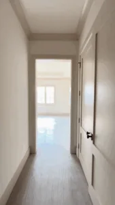 Hallway leading to master bedroom featuring interior painting.