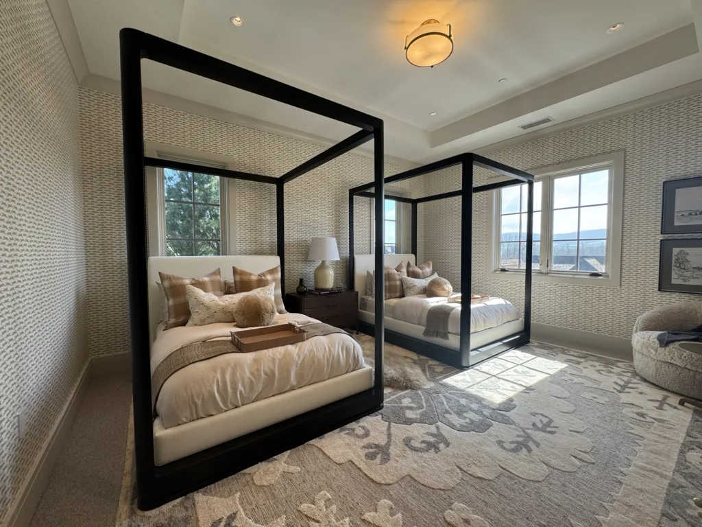 Bedroom interior painting project with beige ceiling and wooden bed frames.
