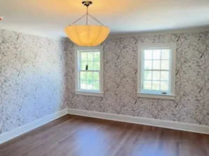 Interior wallpaper installation showing completed walls and natural light