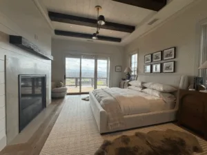 Bedroom interior featuring paint and wallpaper finishes with natural light and soft neutral tones.