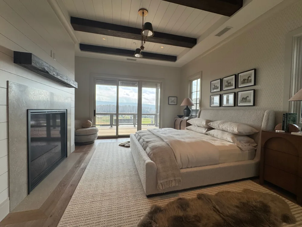 Bedroom interior featuring paint and wallpaper finishes with natural light and soft neutral tones.