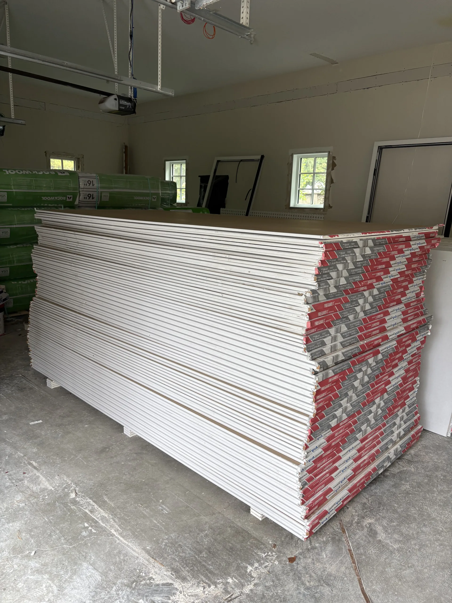 Professional staging area with premium materials ready for a large-scale modern drywall and interior painting project.