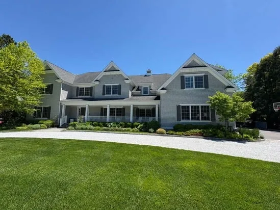 Wide view of the completed exterior house painting on a large residential property featuring grey shingle siding.