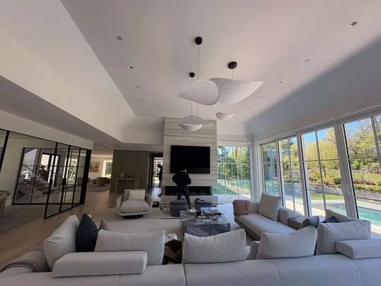 A stunning living room transformed by our recent professional interior painting, providing a durable, elegant finish to the walls and ceiling surrounding the fireplace.